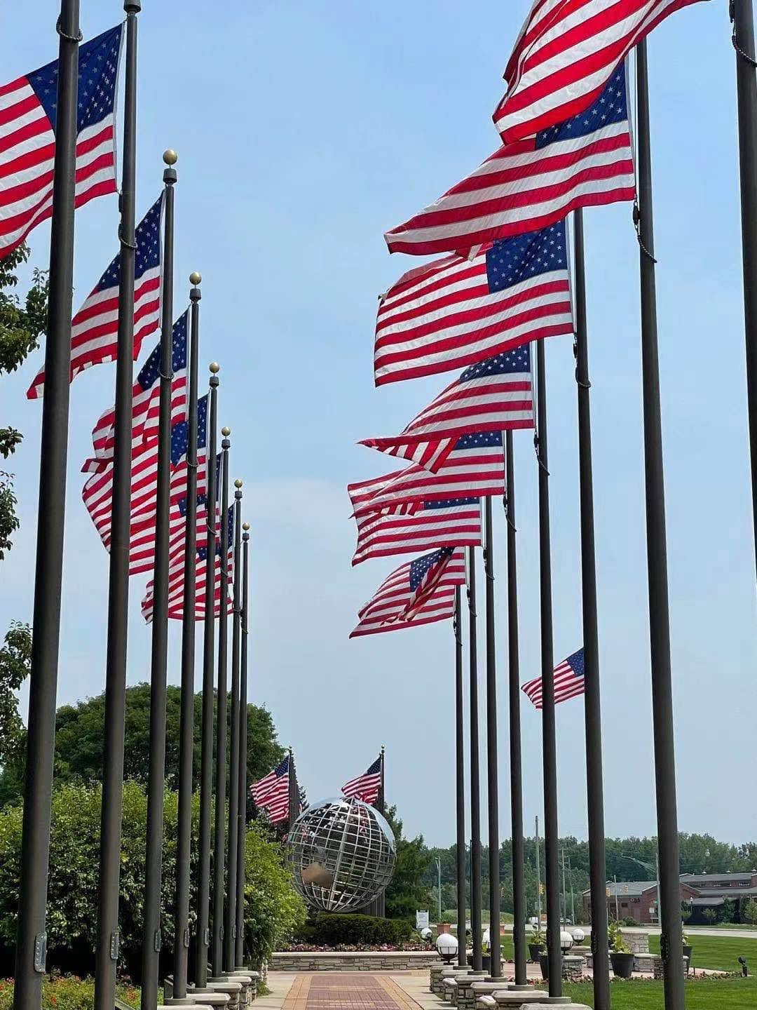 A sunny community walkway lined with flags